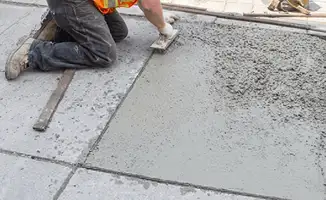 Professional repairing a concrete floor in Des Moines, IA